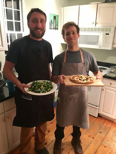 Students prepare dishes for a Dinners with Strangers meal.