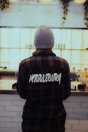 A woman poses in Middlebury-inspired clothing made by Jordan Saint-Louis ‘24 as part of his Tree House Fund project entitled “Humans of Middlebury."