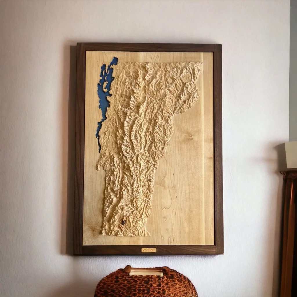 A topographic wood carving of Vermont created by Treeline Terrains.